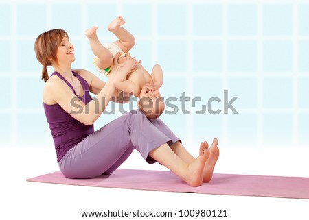 Yoga / Mother with her baby doing yoga exercise.