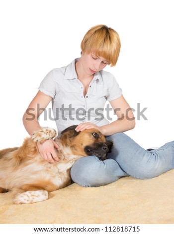 Loving woman with her large gentle crossbreed dog lying with its head on her lap stroking it