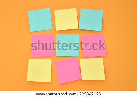 Sticky note on a bright orange wall in square layout