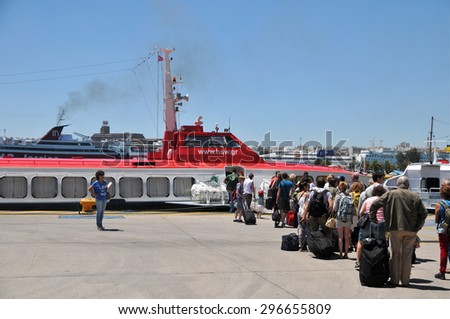 Athens, Greece - May 27, 2013: Tourists and tour guide are waiting for boarding Hellenic Seaway ferry at Piraeus Port in Athens Greece.