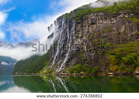 Waterfall in Geiranger fjord Norway - nature and travel background