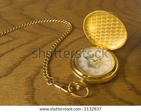Luxurious golden watch on the wooden background