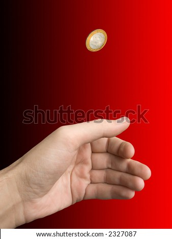 Hand and coin (choice) on blur (black-red) background