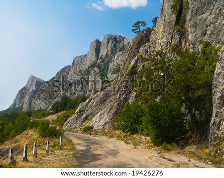 Old road in mountains, abstract travel background
