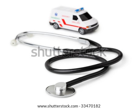 stock photo Stethoscope and toy ambulance car isolated on white background