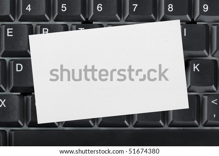 Computer keyboard and paper card - business background