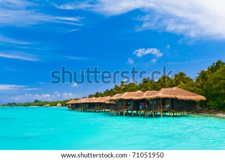 stock photo Water bungalows on a tropical island travel background