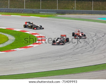 SEPANG, MALAYSIA - APRIL 10: Unidentified racers round one of the curves on the track at the Formula 1 GP race on  April 10 2011 in  Sepang, Malaysia