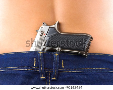 Woman in jeans and pistol gun