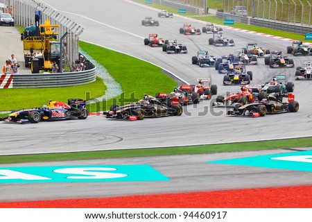 SEPANG, MALAYSIA - APRIL 10: Cars race around the corner on the first lap at the Formula 1 GP, on April 10, 2011 in  Sepang, Malaysia.