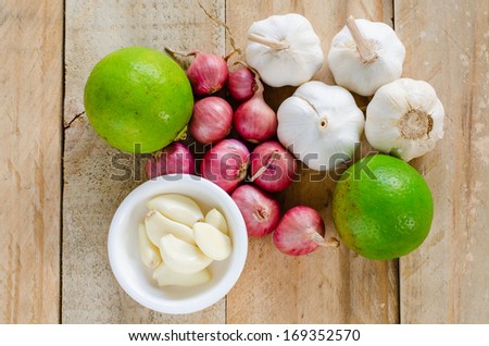 onion  lemon garlic whole and cloves on the wooden background