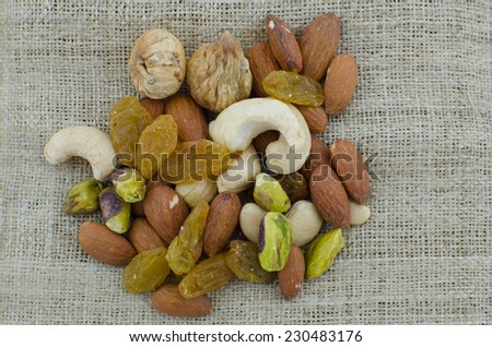 Nuts and dried fruits on vintage cloth still life