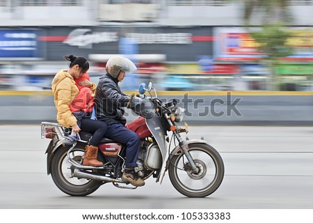 GUANGZHOU-FEB. 26, 2012. Motorcycle taxi on Feb. 26, 2012 in Guangzhou. Although the Guangzhou municipal government has banned motorcycle taxis for safety reasons itÃ¢Â?Â?s still a popular transport mode.