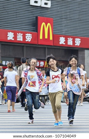 XIANG YANG-CHINA-JULY 3 2012 Teenagers in front of McDonald's on July 3 2012 in Xiang Yang It took McDonald's 19 years to reach 1 000 restaurants in China It plans to raise it to 2 000 by 2013 XIANG YANG-CHINA-JULY 3 2012 Teenagers in front of McDonald's on July 3 2012 in Xiang Yang It took McDonald's 19 years to reach 1 000 restaurants in China It plans to raise it to 2 000 by 2013