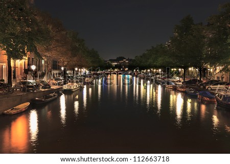 AMSTERDAM-AUG. 18, 2012. Canal by night on Aug. 18, 2012 in Amsterdam. Amsterdam is known as Venice of the North. It has 1,200 bridges and 165 canals and around 2,500 house boats where locals live.