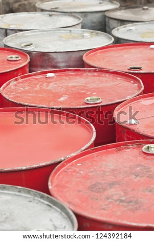 Red and silver colored empty oil-drums