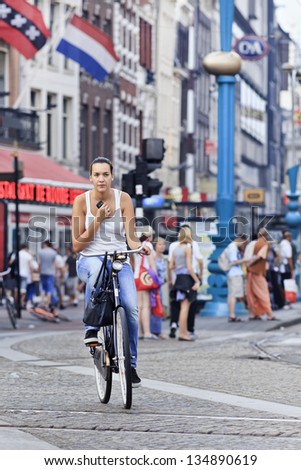 AMSTERDAM-AUG. 19. Cycling girl. In A\'dam 38% of traffic movement in the city is by bike , 37% by car, 25% public transport. In the center, 57% of traffic movement by bike. Amsterdam, Aug. 19, 2012
