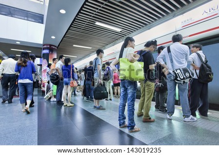 SHANGHAI-JUNE 6. Commuters at subway station. 12 metro lines and 287 stations, with an operating route length of 439 KM, making Shanghai the third longest metro in the world. Shanghai, June 6, 2013.