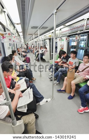 SHANGHAI-JUNE 6. Passengers in train car. With 2.276 billion rides (2012) Shanghai is the world\'??s fifth busiest metro. Daily ridership record on 03-09-2013: 8.486 million. Shanghai, June 6, 2013.