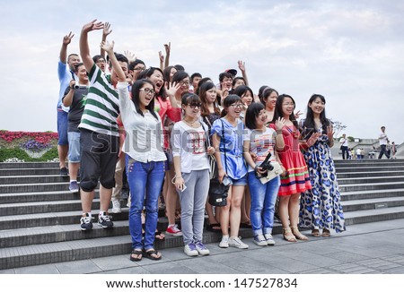 SHANGHAI-JUNE 6. Cheerful Chinese tourist group. Shanghai wants develop tourism into strategic industry, create 300,000 jobs, contribute 8.5 percent to city\'s GDP by 2015. Shanghai, June 6, 2013.