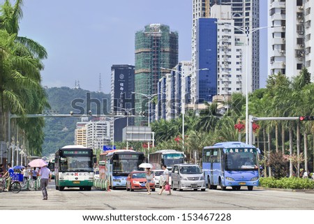 ZHUHAI-CHINA-SEPT. 7. Buses at a traffic light in Zhuhai center, a city on the southern coast of Guangdong, one of China\'s premier tourist destinations, called Chinese Riviera. Zhuhai, Sept. 7, 2013