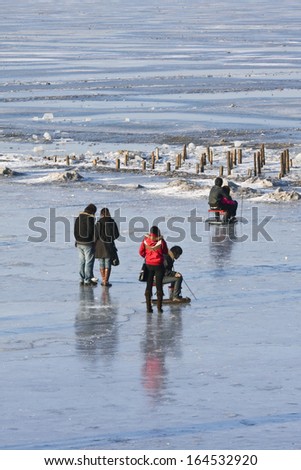 HARBIN-MARCH 7. City dwellers enjoy frozen Songhua River. Harbin is located Northeast China under influence of cold Siberia winter wind. Average temperature winter is -16.8 Ã?Â°C. Harbin, March 7, 2009