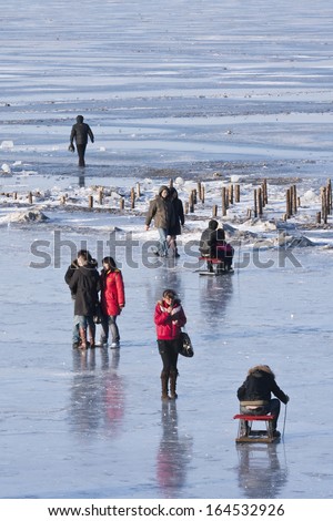 HARBIN-MARCH 7. City dwellers enjoy frozen Songhua River. Harbin is located Northeast China under influence of cold Siberia winter wind. Average temperature winter is -16.8 Ã?Â°C. Harbin, March 7, 2009