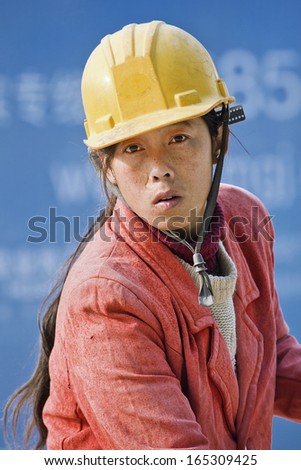 BEIJING-OCT. 29. Female construction worker. Among millions of Chinese migrant workers, one-third are women, they get only paid 33 percent of what men earn for the same work. Beijing, Oct. 29, 2007.
