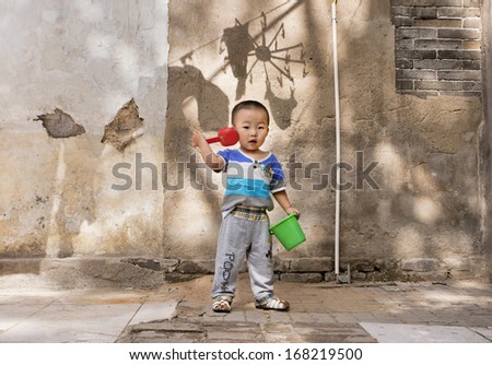BEIJING-MAY 20. Five years old Jialin in a hutong. Hutongs are alleys formed by lines of traditional courtyard residences. Last decades many Beijing hutongs were demolished. Beijing, may 20, 2010.