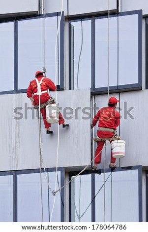 BEIJING - APRIL 28, 2009. Window cleaners at work. They are known as \'spider-men\'Â� because they often entrust their lives to a single thread, made of hemp and nylon thick as a gearstick.