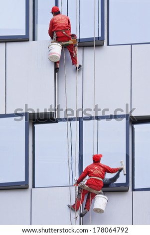 BEIJING - APRIL 28, 2009. Window cleaners at work. They are known as \'spider-men\' because they often entrust their lives to a single thread, made of hemp and nylon thick as a gearstick.