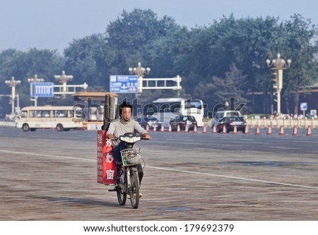 BEIJING-JUNE 1, 2013. Worker transports gauze rolls on his electric bike in the early morning. In just a decade, the number of electric-bike riders in China went from near zero to over 150 million.
