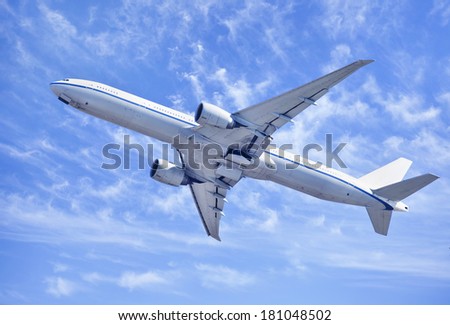 Twin-engine jet-liner climbing upwards after take-off.
