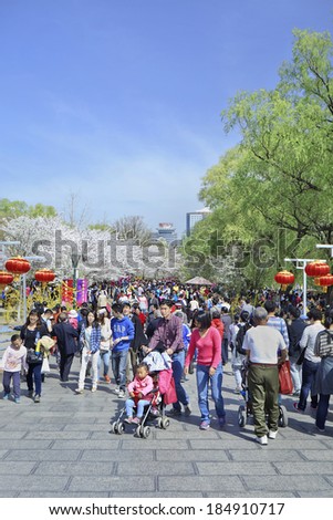 BEIJING-MARCH 30, 2014. Crowd at Yuyuantan Park. Spring cherry tree blossom attracts thousands of tourists. The park covers an area of 136.69 hectares and water surface spans an area of 61 hectares.