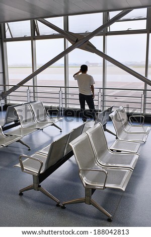 KUNMING, CHINA-JUNE 21, 2010. Man calls in an empty hall at Kunming Wujiaba International Airport.  The airport handled 20,192,243 passengers last year, making it China\'??s  seventh busiest airport.