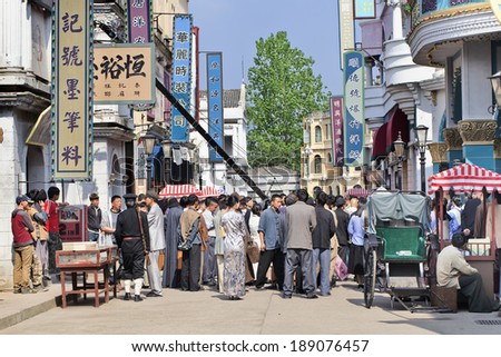 HENGDIAN-CHINA-APRIL 14, 2014. Film set with extras at Hengdian World Studios. With 495,995 sq. meter the largest movie town in Asia, construction began mid-1990s and has been ongoing ever since.
