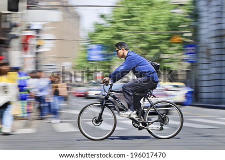 SHANGHAI-MAY 3, 2014. Man on Giant ATB bike. Giant is a Taiwanese bicycle manufacturer, recognized as the world\'s largest bicycle maker with manufacturing facilities in Taiwan, Netherlands, and China.
