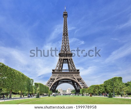 The majestic Eiffel tower in Paris against a blue sky The majestic Eiffel tower in Paris against a blue sky