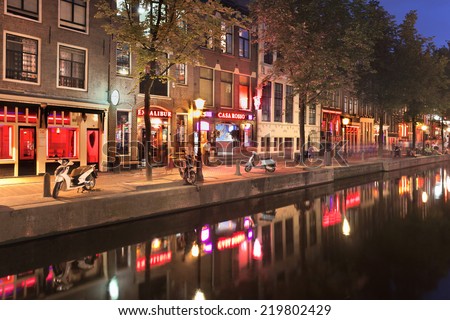 AMSTERDAM-AUG. 19, 2012. Red Light District at night. It is probably the world's most famous in its kind. There are over 500 windows in the Amsterdam Red Light District and about 1000 working girls.