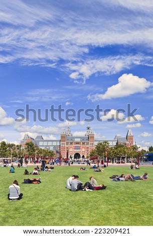 AMSTERDAM-AUG. 24, 2014. People enjoy a summer day on Museum Square. Several museums are located around the very touristy square: Rijksmuseum, Van Gogh Museum, Stedelijk Museum and Diamond Museum.