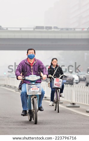 BEIJING-OCT. 11 ,2014. Man on e-bike in smog blanketed city. A concentration of PM2.5, small particles that poses a huge health risk, hit 462 according the U.S. Embassy pollution monitor in Beijing.