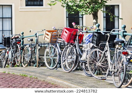 Parked bicycles on a railing in the historic canal belt, Amsterdam, The Netherlands