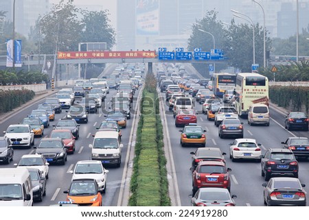 BEIJING-OCT. 19, 2014. Traffic jam in smog covered city. Beijing smog alert went to orange, means \'hazardous\', maily caused by exhaust emission of five million cars and coal burning in close regions.