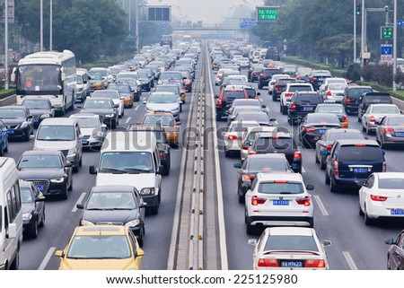 BEIJING-OCT. 19, 2014. Traffic jam in smog covered city. Beijing smog alert went to orange, means hazardous, mainly caused by exhaust emission of five million cars and coal burning in close regions.
