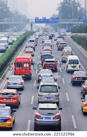 BEIJING-OCT. 19, 2014. Traffic jam in smog covered city. Beijing smog alert went to orange, means hazardous, mainly caused by exhaust emission of five million cars and coal burning in close regions.