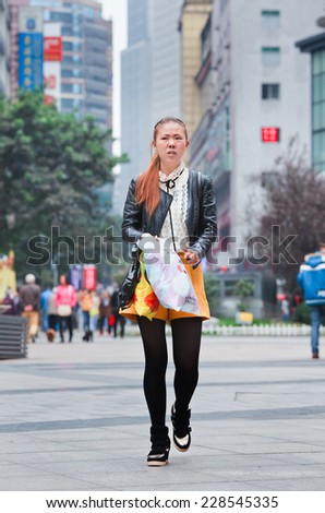CHONGQING-NOV. 4, 2014. Trendy girl in shopping area. According a research, Chinese consumers under the age of 28 have zero savings because they spend everything on clothes and consumer electronics.