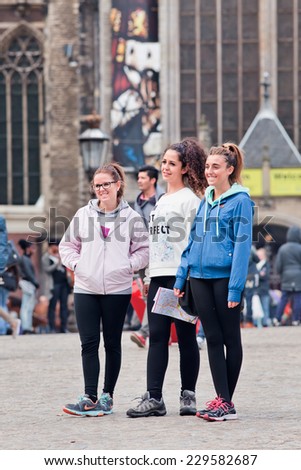 AMSTERDAM-AUG. 26, 2014. Tourists on Dam square. Amsterdam is the most visited Dutch city (4.3 million foreign guests). It\'s called Venice of the North because of its 1,200 bridges and 165 canals.