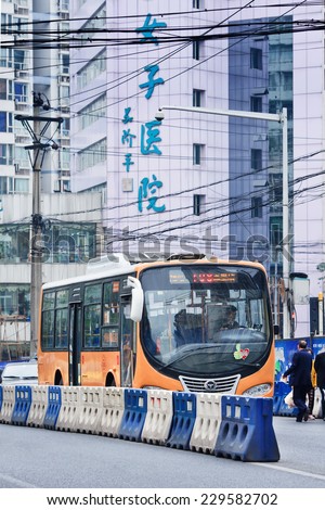 CHONGQING-NOV. 4, 2014. Public transport. Most popular transport mode is public bus. Start price is CNY 1 for common buses and CNY 1.5 for air-conditioned buses. Running hour buses is 5:30 to 21:00.