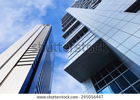 Sharp lines from modern architecture against a blue sky.
