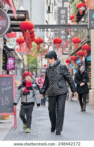 SHANGHAI-DEC. 4, 2014. Visitors at Tianzefang art area. Known for its small craft stores, coffee shops, trendy art studios and narrow alleys it became a very popular tourist destination in Shanghai.
